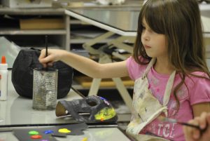 Auryanna Belcher, 6, paints during a previous Kemper Kids Art Camp.