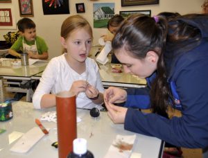 WWU student Heather Cartwright helps Emerson Fansler with her project. 