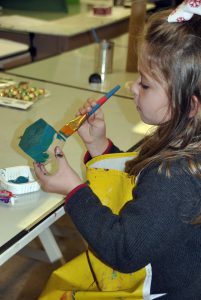 Bella Webb works on an art project during art camp.