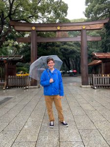 Ben standing with an umbrella