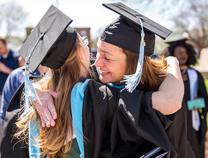 Graduates hugging