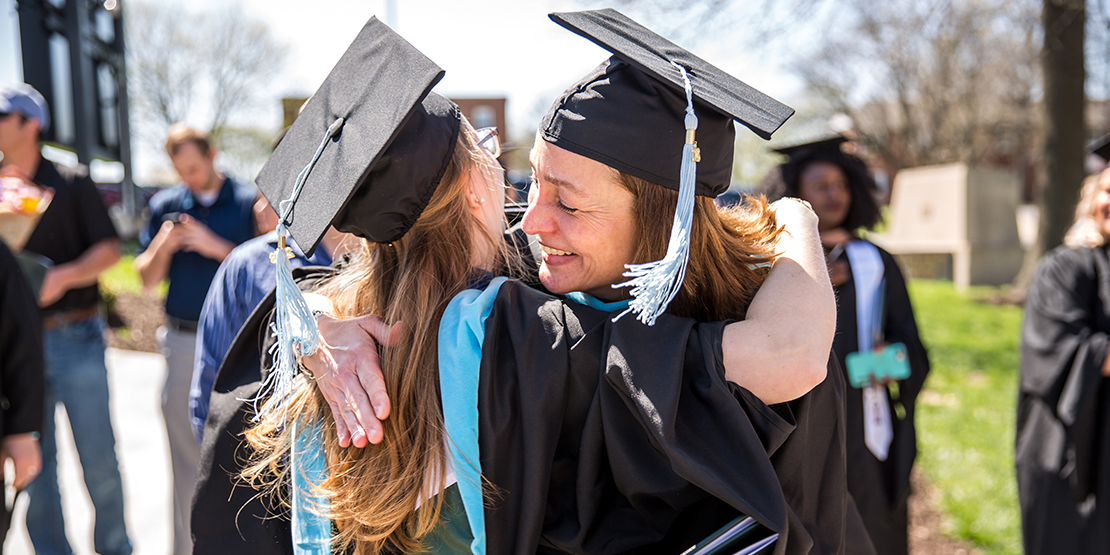 Graduates hugging