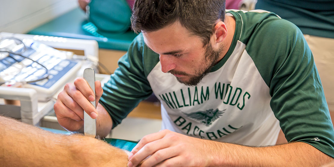 Student wrapping a knee