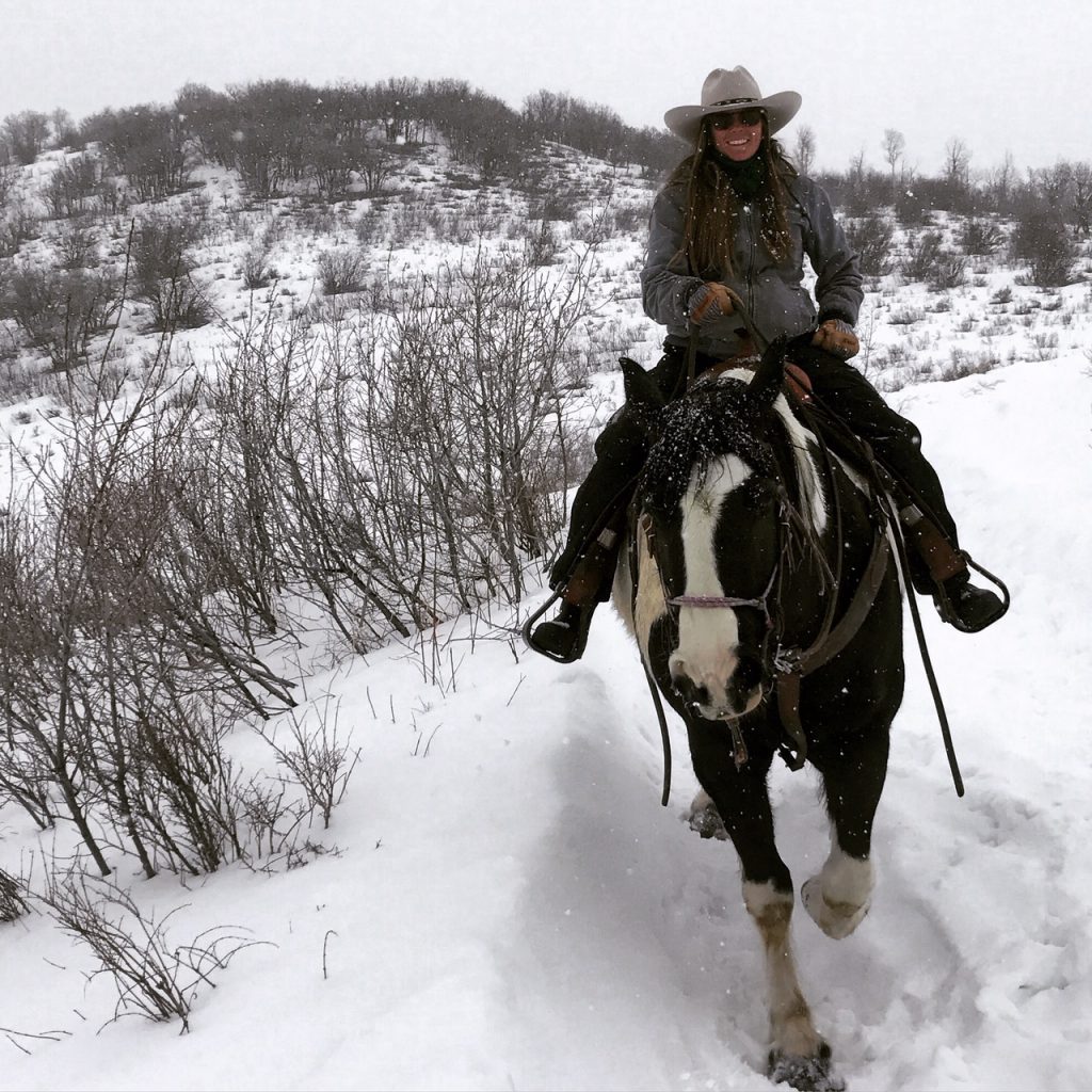 Mandy Griffey riding western on a horse in Colorado 