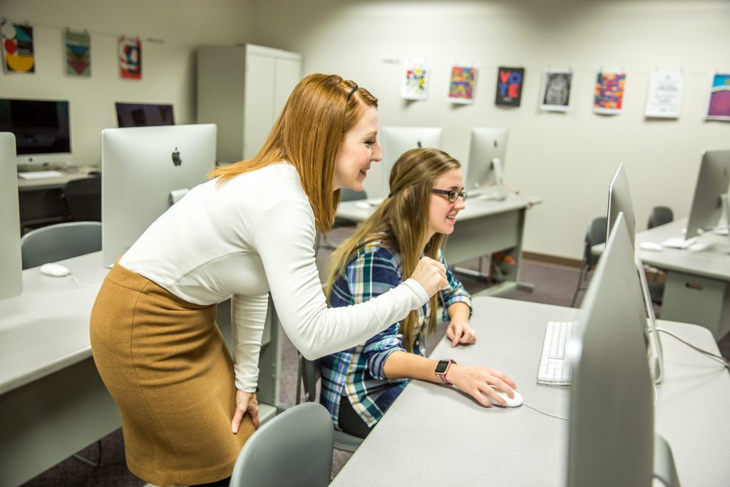 Dr. Irons helping a student