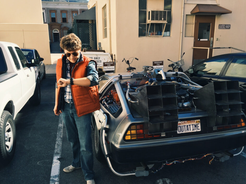 Joshua Potter posing as Marty McFly with the DeLorean from the Back to the Future trilogy.