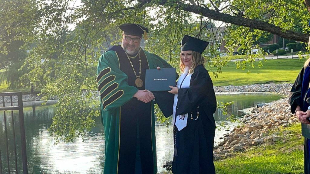 Dr. Moreland presents Sara Schaefer with diploma