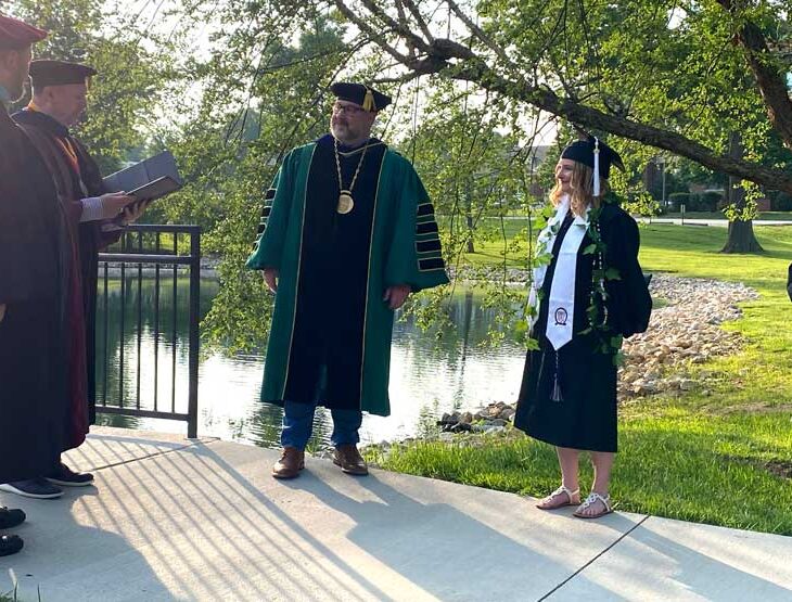 Graduate Sara Schaefer and the WWU administration on the senior bridge