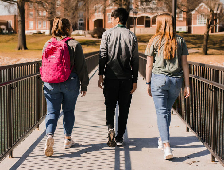 students walking across bridge on WWU campus