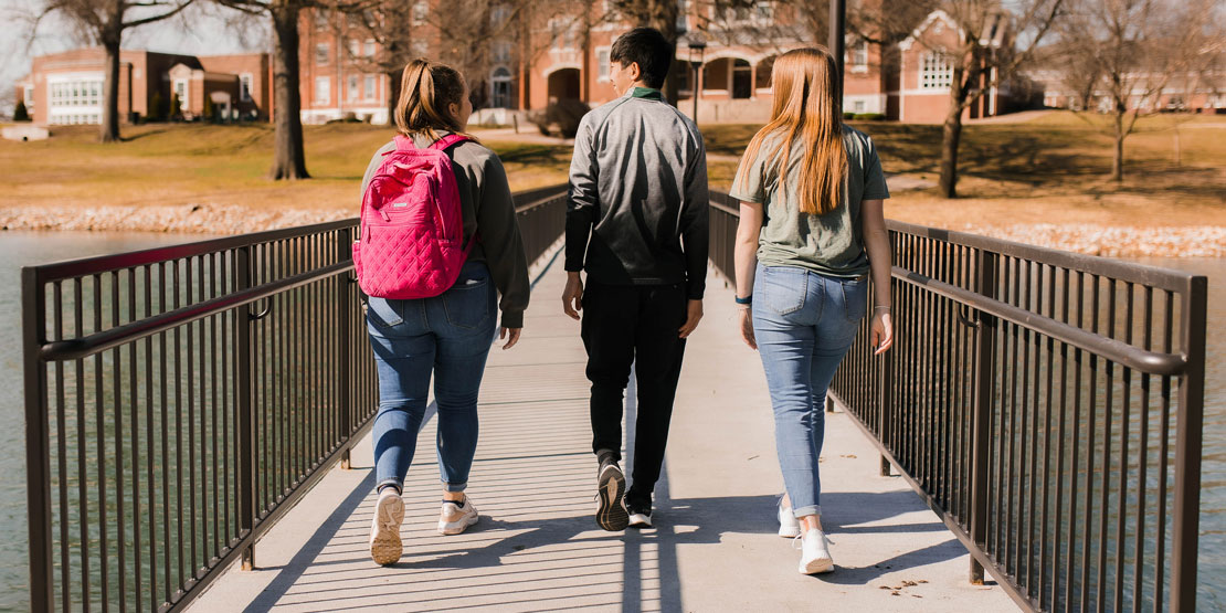 students walking across bridge on WWU campus