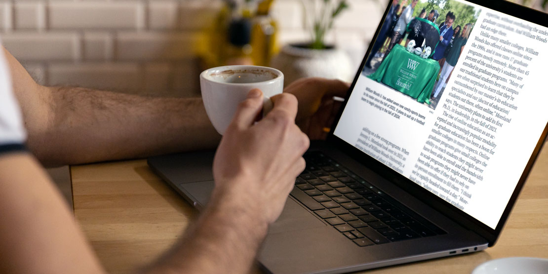 Person reading the Chronicle of Higher Education article online with a cup of coffee.