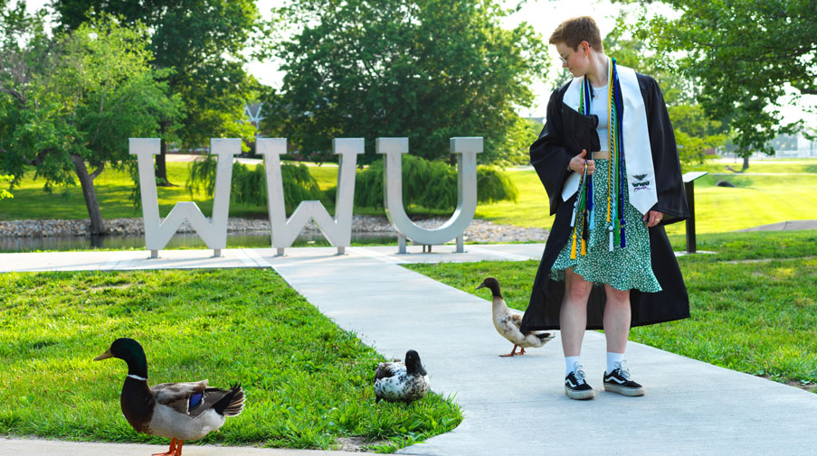 Aurora Lucie Henriksen in front of the WWU statue letters on campus