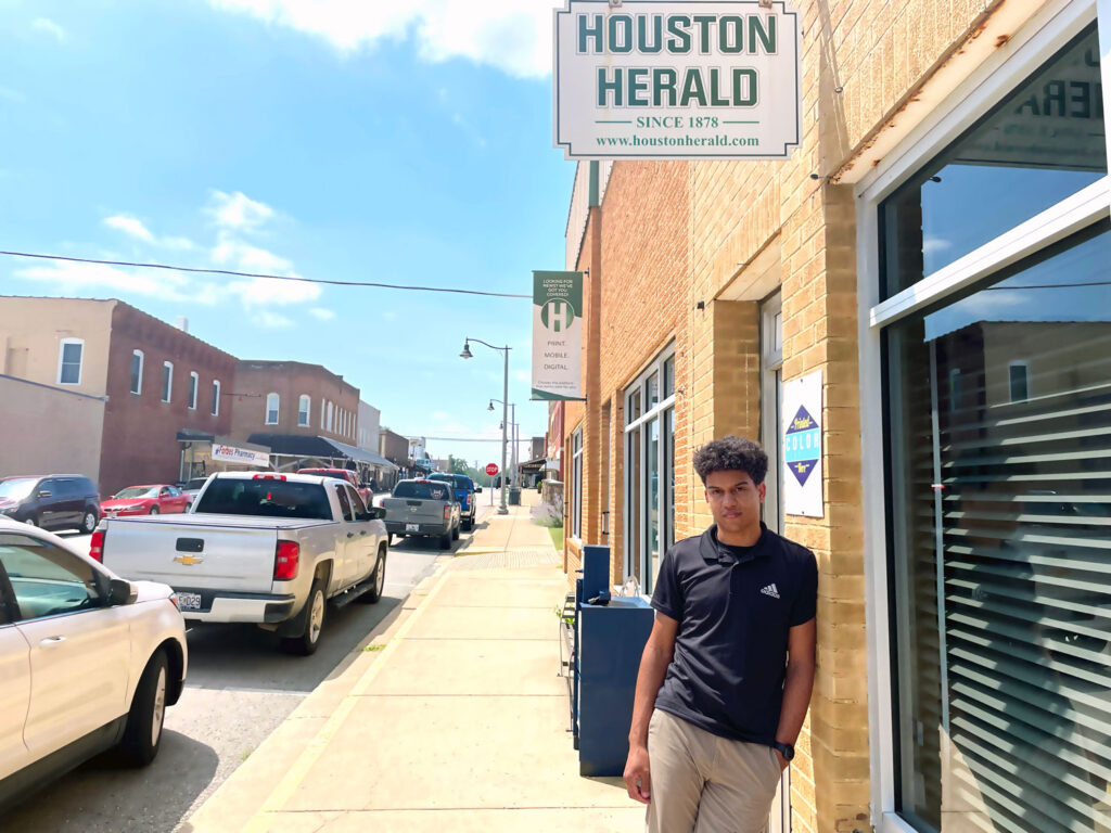 Isaiah Buse standing outside of the Houston Herald newspaper building