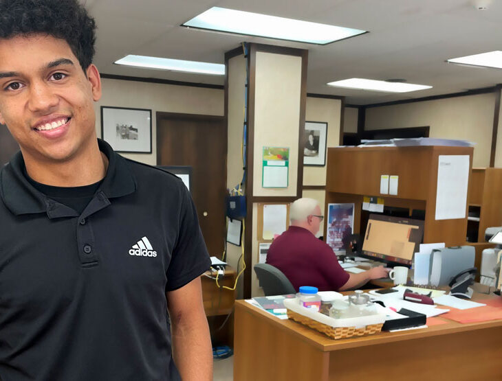 Isaiah Buse standing in lobby of the Houston Herald newspaper