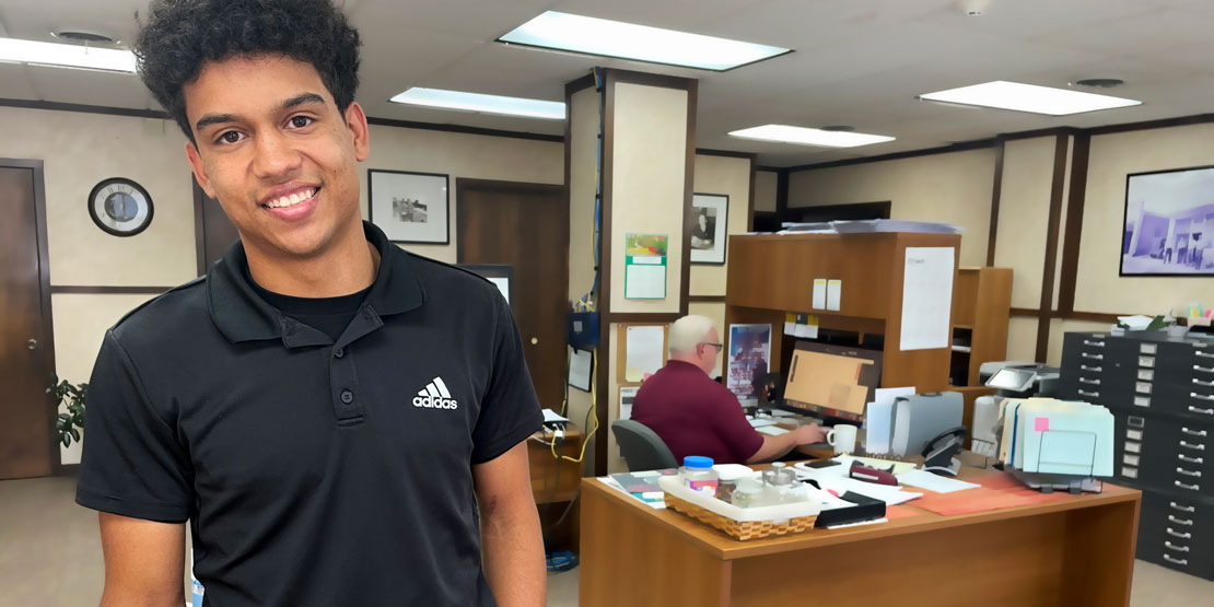 Isaiah Buse standing in lobby of the Houston Herald newspaper