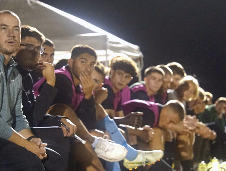 Coach Tommy Nienhaus sits with the soccer team