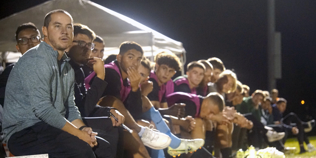 Coach Tommy Nienhaus sits with the soccer team