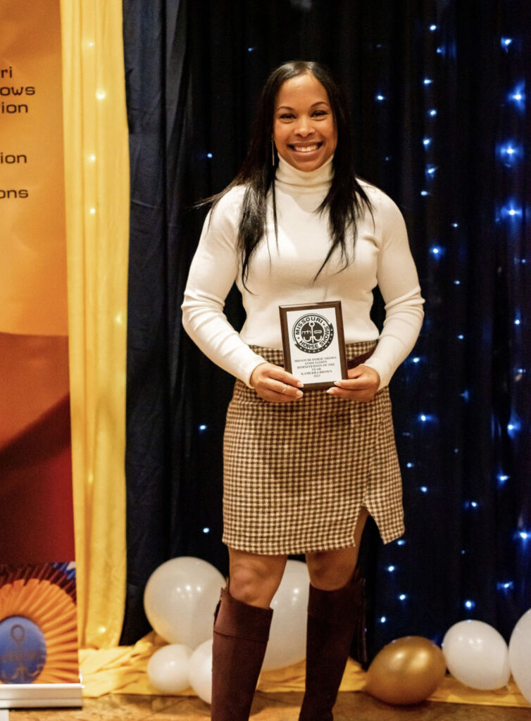 Kamerra Brown poses with award