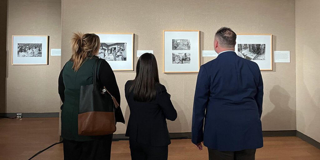 Visitors viewing the photographs in the art gallery