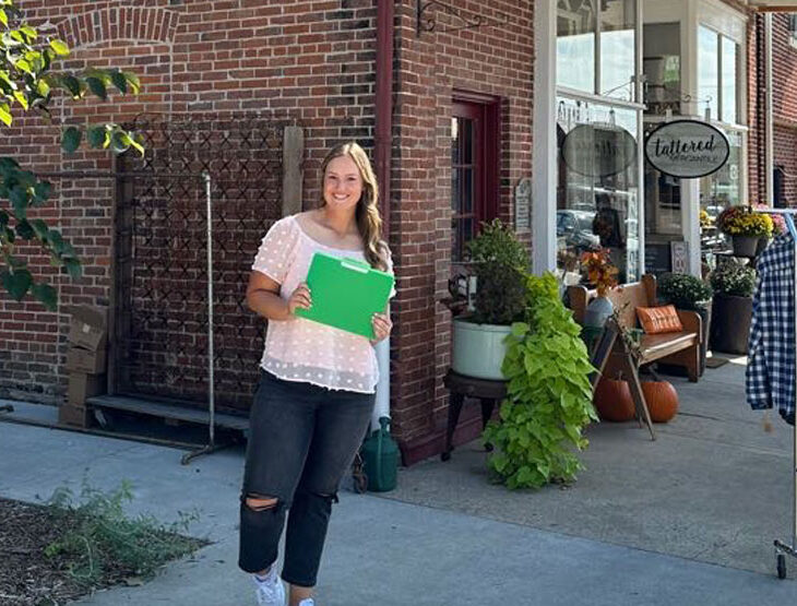 Allyson Hollrah standing in front of her business in Hermann