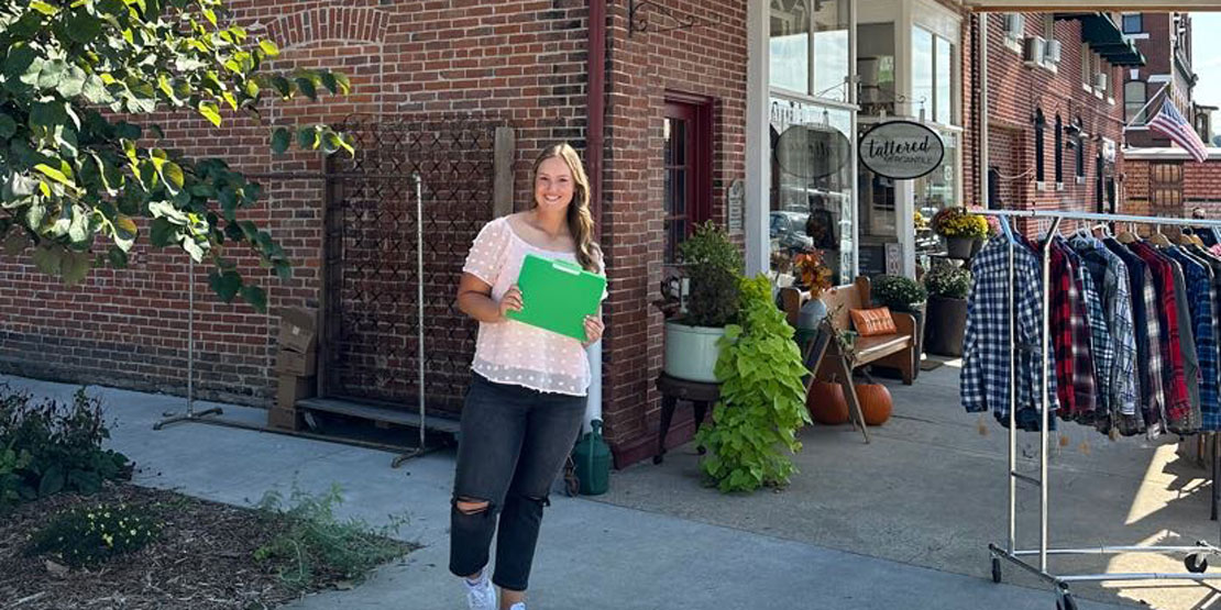 Allyson Hollrah standing in front of her business in Hermann